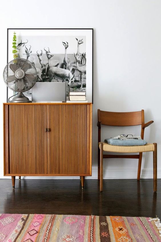 A stained fluted cabinet on cone legs will fit a mid century modern, boho or even contemporary space