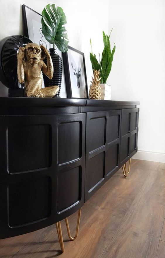 A stylish black rounded sideboard with paneling and hairpin legs is a lovely idea for a mid century modern space