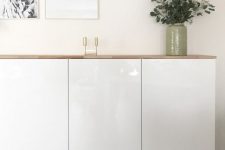 a stylish floating sideboard made of IKEA Metod cabients and a light-colored wooden tabletop