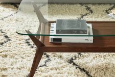 a stylish mid-century modern coffee table with a rich-stained and a glass tabletop and cool legs is a cool solution for your living room