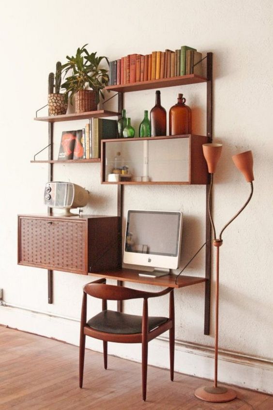 A whole mid century modern wall mounted system with open shelves and some cabinets plus a matching chair