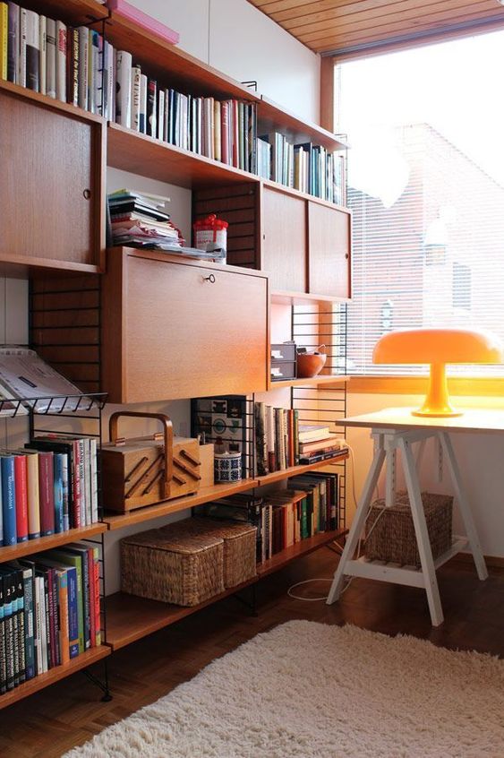 an oversized bookcase with open shelves and closed storage units is ideal for a mid-century modern home office