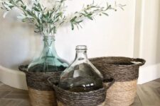 baskets with oversized bottles, with greenery and olive branches add a farmhouse feel to the space