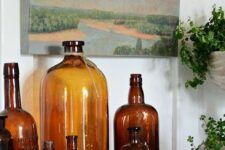 brown vintage bottles of various sizes will style your mantel in a beautiful way, with a rustic and vintage feel
