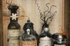 vintage Halloween decor with lovely bottles covered with spider web, skulls and twigs is a very cool and bold solution for decorating or drink styling
