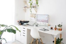 a Nordic home office with a white desk, file cabinets, a white chair, wall-mounted shelves, potted plants and touches of gold