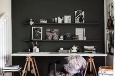a home office with a dramatic black wall