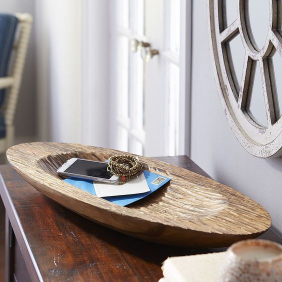 a carved vintage dough bowl as a trinket dish is a stylish way to add a touch of vintage