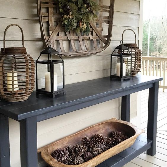 a dough bowl fiilled with pinecones is a stylish idea for a rustic entryway