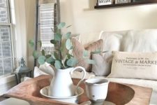 a dough bowl with vintage tableware and a fresh eucalyptus arrangement for a vintage farmhouse space
