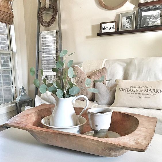 a dough bowl with vintage tableware and a fresh eucalyptus arrangement for a vintage farmhouse space