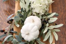 a simple neutral fall DIY centerpiece using a vintage rustic dough bowl, hydrangeas, olive branches and milk paint pumpkins
