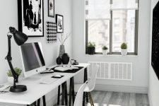 a small Scandinavian home office with a two black and white trestle desks, white chairs and black and white artworks