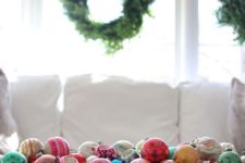 a stylish Christmas decoration of a vintage dough bowl and colorful vintage Christmas ornaments