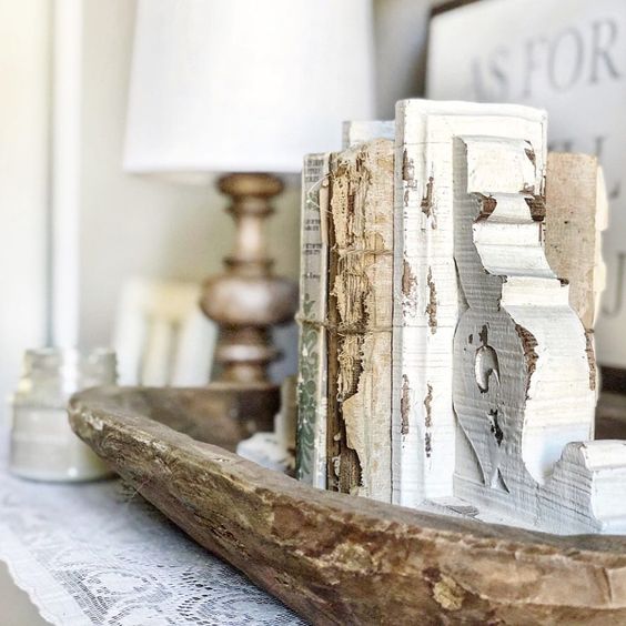 a vintage dough bowl with antique books and bookends brings a touch of vintage and elegance