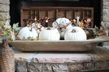 a vintage dough bowl with white pumpkins, faux leaves and berries for fall home decor