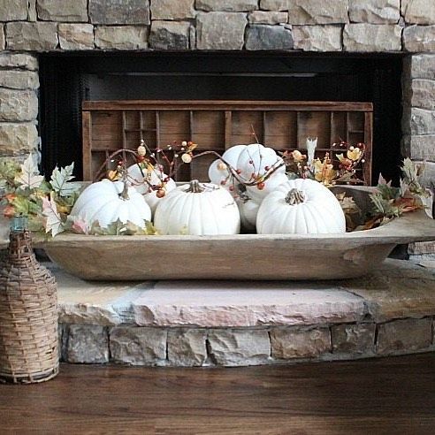 a vintage dough bowl with white pumpkins, faux leaves and berries for fall home decor