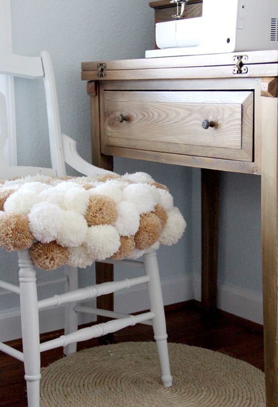 cover a usual chair with pompoms to make it cozy and soft and it will be whimsier and cooler
