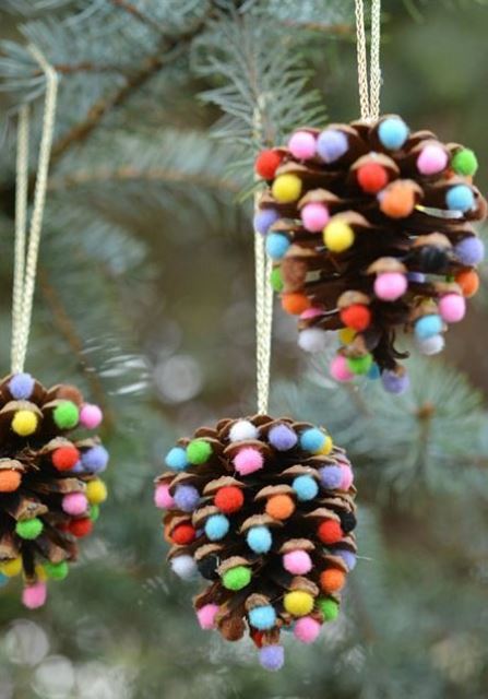 pinecone Christmas ornaments accented with bright pompoms are bright and easy decorations for holidays