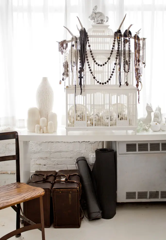 A birdcage could act as a beautiful jewelry display stand where you can hang your collection of necklaces and beads.