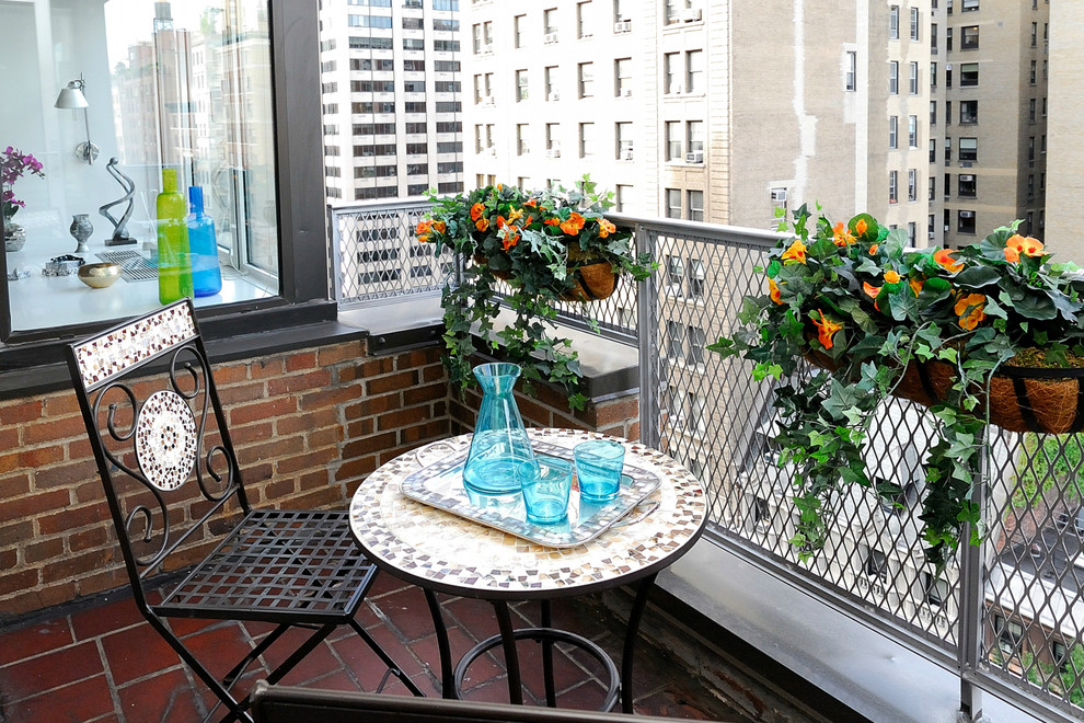 a tiny balcony with a small table and chair, bold potted plants is a cool space to have a drink or enjoy fresh air