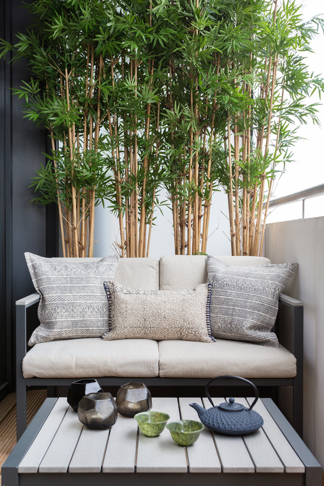 A small sofa, a coffee table and a bamboo wall would make a balcony a perfect place for an afternoon tea. (<a href="http://www.zulufish.co.uk">Zulufish</a>)