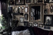 a Gothic-inspired living room with refined black furniture, a gallery wall with artworks and mirrors and potted greenery