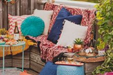 a bright boho Moroccan terrace with colorful textiles, colorful pillows, baskets and colorful fruniture