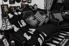 a fun Gothic living room done in black and white, with refined furniture, printed pillows, a catchy gallery wall and textiles