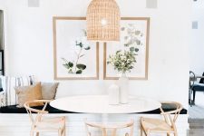a lovely modern farmhouse dining room with a built-in bench, an oval table and wooden chairs, a woven pendant lamp