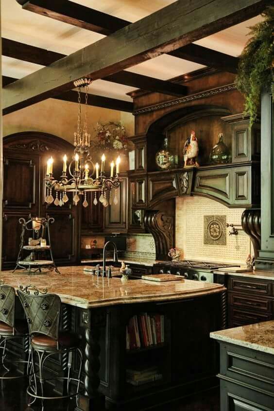 a moody Gothic kitchen with dark heavy furniture, a white tile backsplash, a chic ktichen island with a stone countertop, catchy stools and a vintage chandelier