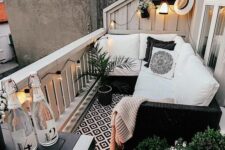 a small Scandinavian balcony with a printed rug, a wicker corner sofa, potted plants and blooms and some lights