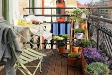 a small balcony with folding metal furniture and potted geenery and blooms is a simple and cozy space to enjoy fresh air