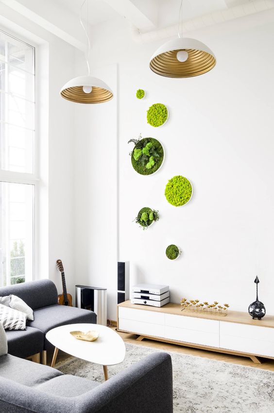 a small yet bright arrangement of moss and greenery wall art pieces adds to the modern space