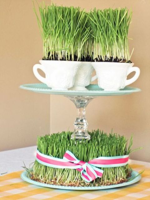 a whimsical centerpiece with wheatgrass and a stand with teacups with wheatgrass is a creative idea for spring