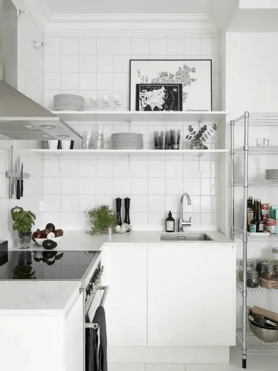 a white Nordic kitchen with a white tile backsplash, stainless steel appliances is a very airy space