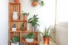 crates with potted greenery are a nice idea for lacony decor – though you may store anything you want there