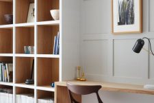 a beautiful minimalist home office with built-in bookshelves and a small built-in desk is a stylish space