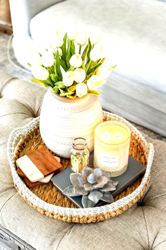 a chic rounded vase with white tulips and candles is a nice decoration for spring, it's easy to recreate