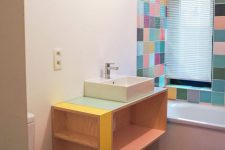a contemporary bathroom with bold tiles around the tub, a floating storage vanity with colorful touches is amazing and fresh
