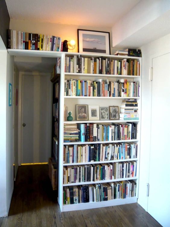 A corner all covered with bookshelf built ins is a stylish way to use your awkward nook and store some books