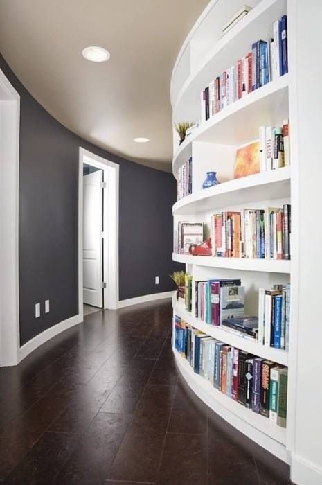 A curved wall with built in bookshelves will save a lot of space you may need for books and will make use of the wall