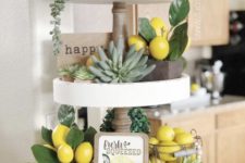 a farmhouse spring kitchen with succulents, fake lemons and greenery, an artwork, beads and a vine ball