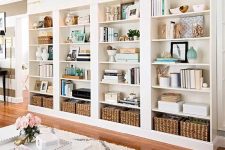 a large built-in bookshelf unit with lots of books, vases, baskets and candles is a cool idea for a home office