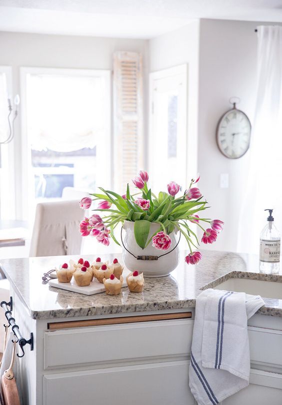 a large white porcelain jar with bright pink tulips is a bold spring centerpiece that looks fresh and romantic