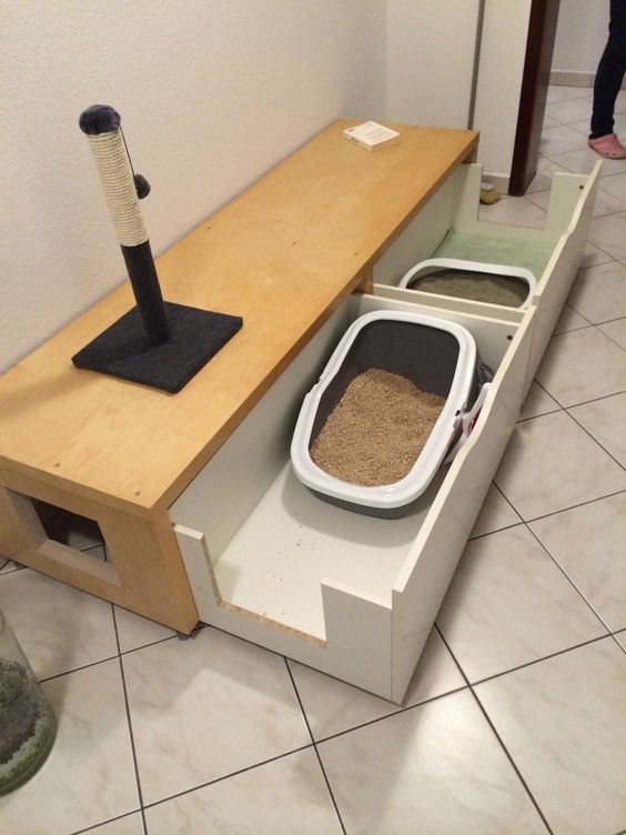 a long storage bench with two drawers and cat toilets inside is a perfect solution for a home with two cats