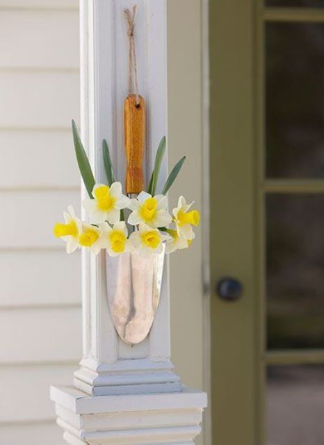 a lovely outdoor decoration of a shovel and daffodils will give a sweet rustic touch to your space