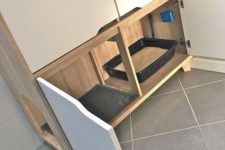 a minimalist cabinet with a cat litter box inside and more storage space aobve – it may be used for all the necessary things
