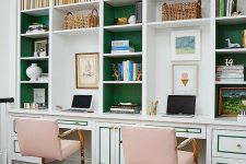 a refined home office with built-in bookshelves with green backing and pink metallic chairs and a faux zebra rug