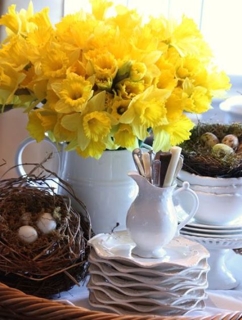 a rustic decoration of fake nests with eggs, a white jug with daffodils can be used as a spring centerpiece